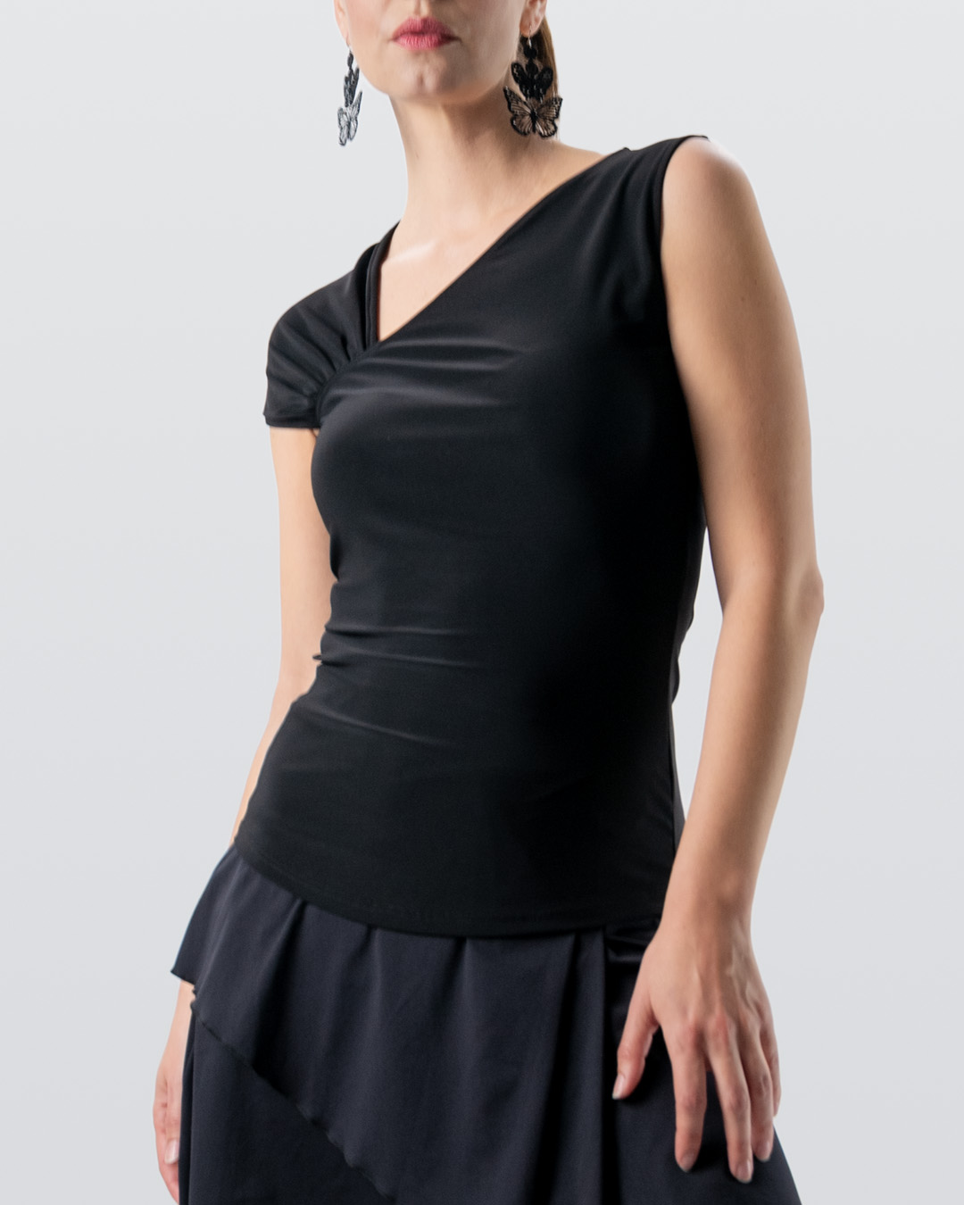 Top de danza slim-fit en negro con cuello en V asimétrico y diferentes diseños de mangas de Werner Kern